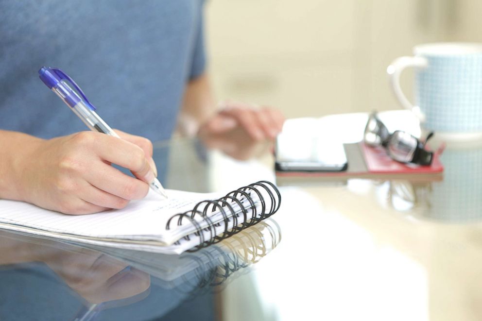 PHOTO: A woman writes in a notebook in this undated stock photo.