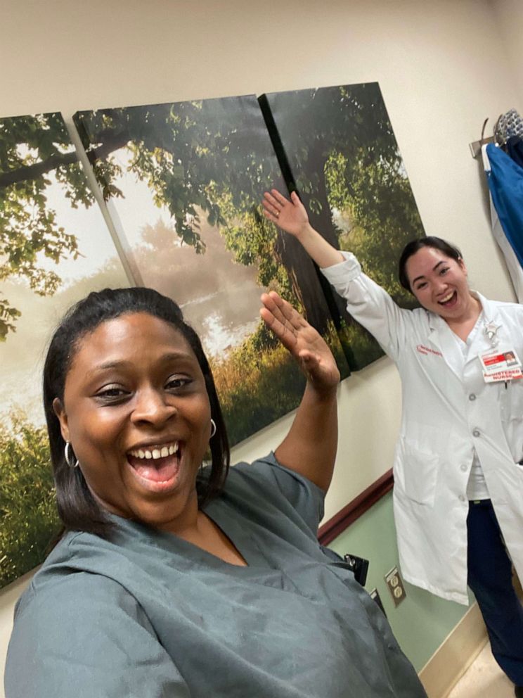 PHOTO: Dawn Jones and Kym Villamer, two health care workers at New York Presbyterian Queens, pose for a photo amid their day singing to patients and hospital staff.