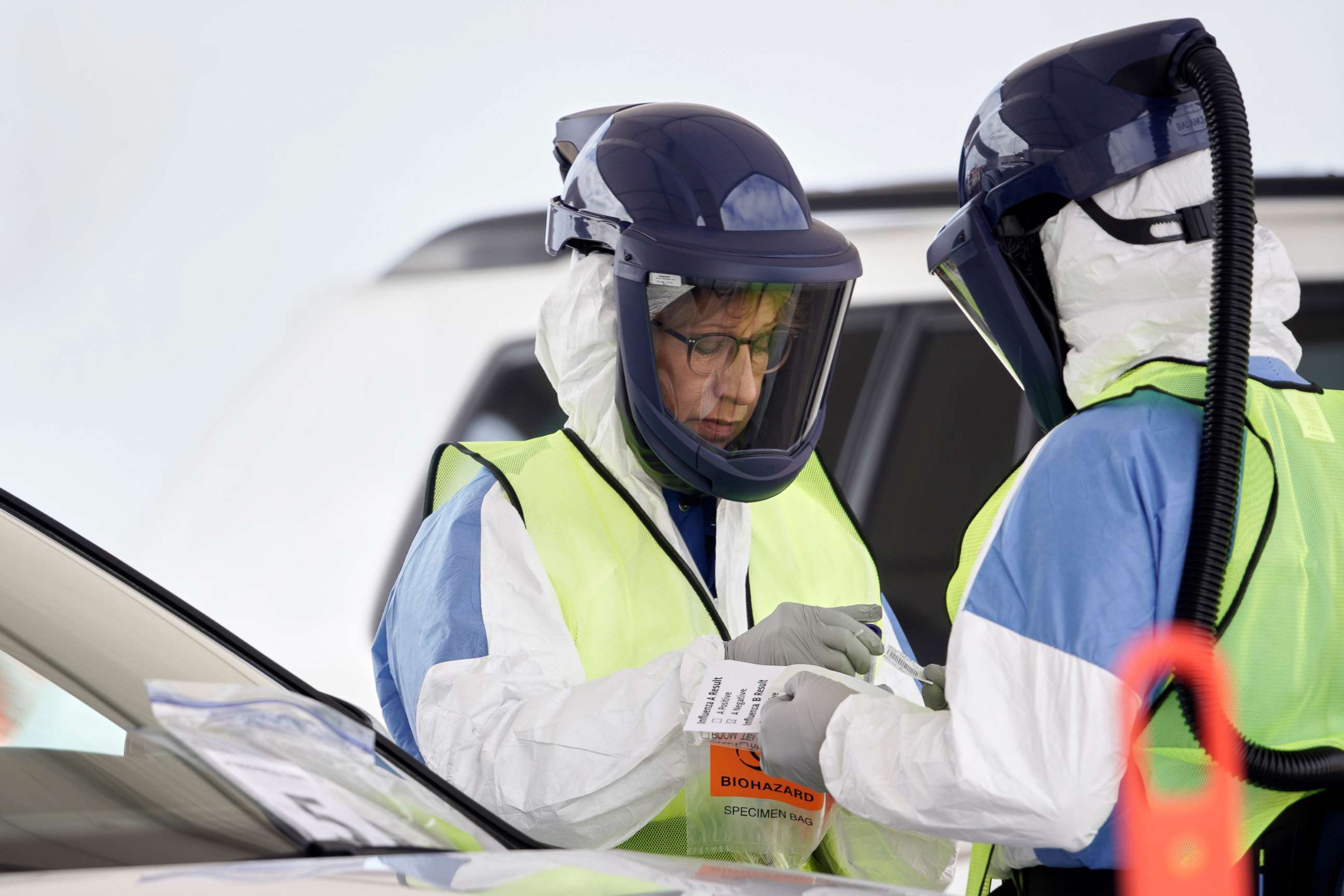 PHOTO: Nurses in protective gear handle a test for the coronavirus at a drive-through testing location at Bryant Health's LifePointe campus in Lincoln, Neb., March 24, 2020. 