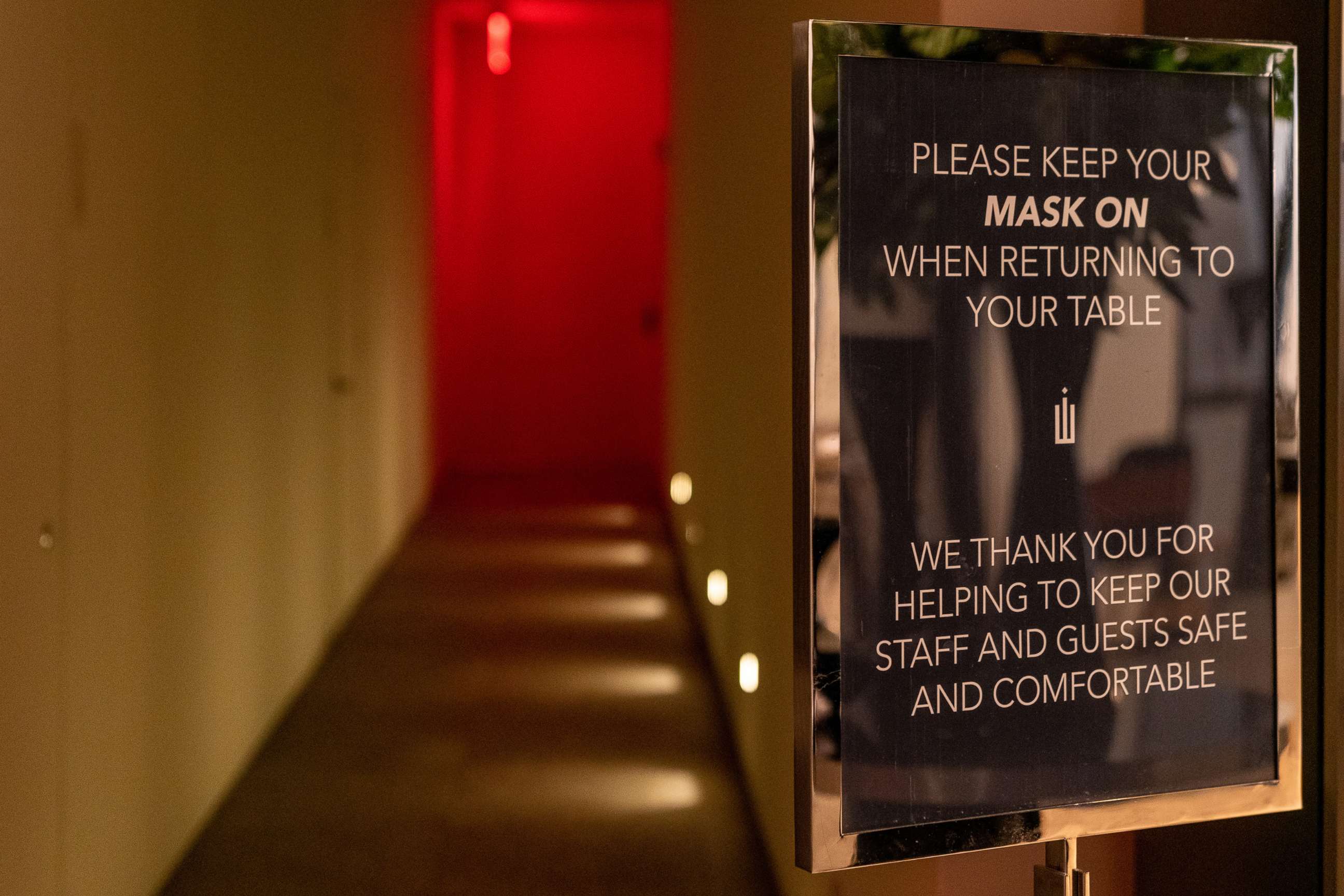PHOTO: A sign asks customers to keep a mask on while returning to tables at Crown Shy restaurant in New York City, on Sept. 26, 2020. New York City will allow indoor dining rooms at 25% capacity beginning Sept. 30.