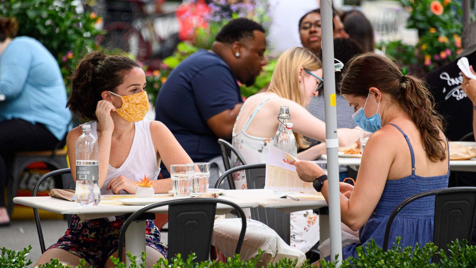 PHOTO: People wear protective face masks at an outdoor restaurant in the Flatiron District of New York, July 26, 2020.