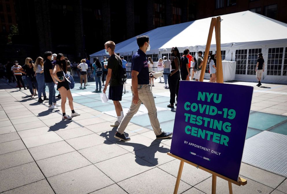 PHOTO: In this Aug. 18, 2020, file photo, people wear protective masks as they wait in line at a COVID-19 testing site set up for returning students, faculty and staff on the main campus of New York University in New York.