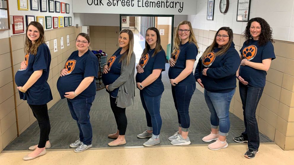 PHOTO: The seven pregnant teachers pose in their due date order in the front hall at Oak Street Elementary in Goddard, Kan.