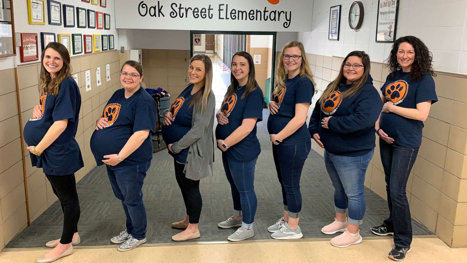 PHOTO: The seven pregnant teachers pose in their due date order in the front hall at Oak Street Elementary in Goddard, Kan.