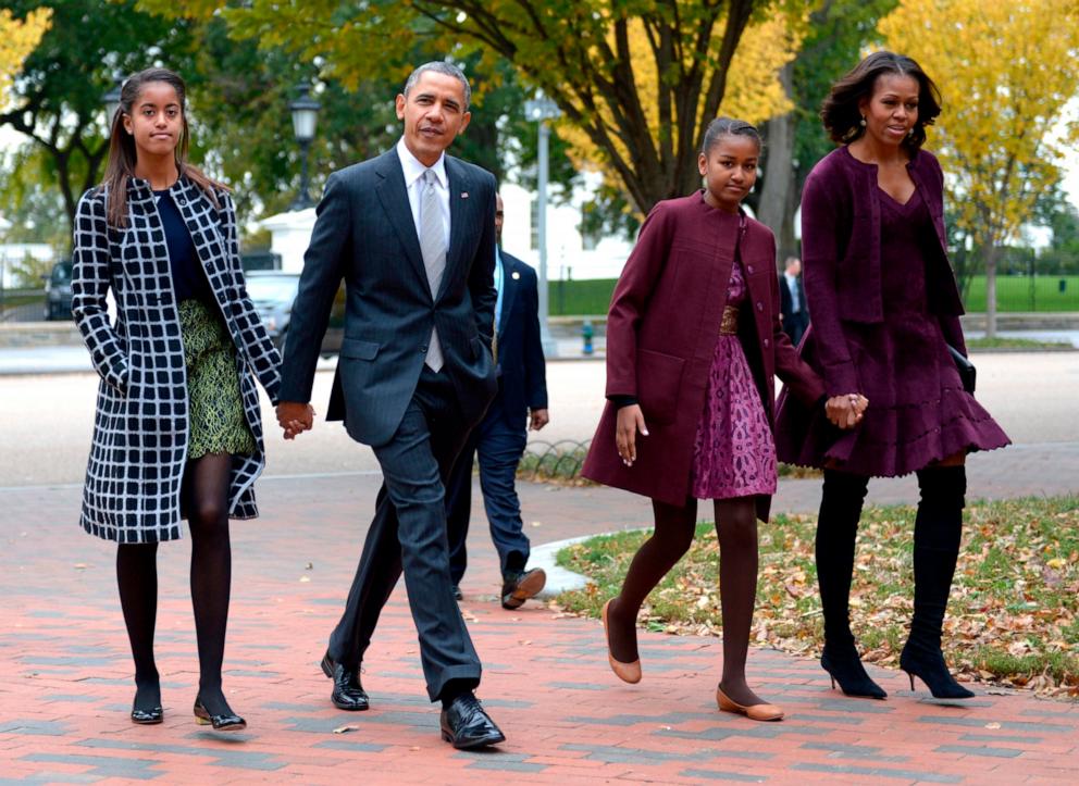 PHOTO: President Barack Obama walks with his wife Michelle Obama, and two daughters Malia Obama and Sasha Obama, through Lafayette Park to St John's Church to attend service October 27, 2013 in Washington, DC.