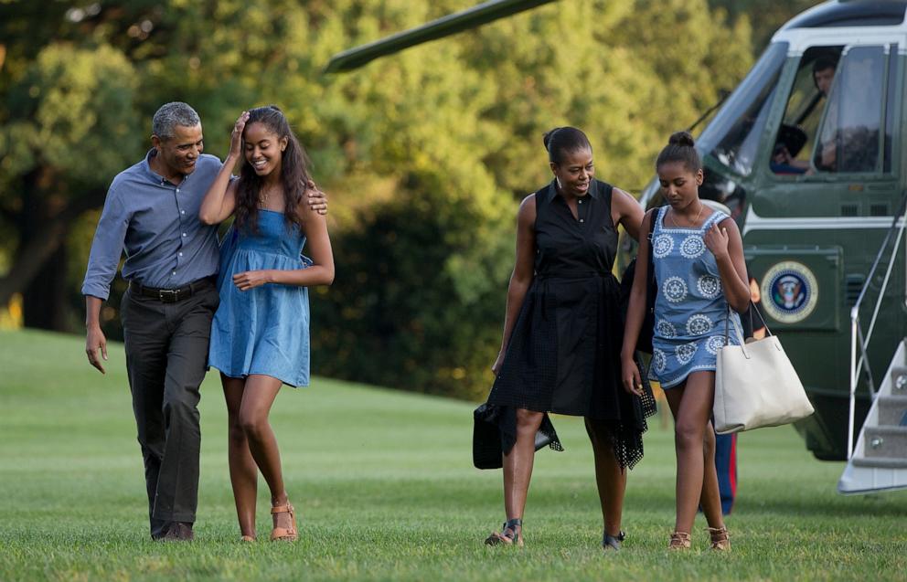 PHOTO: President Barack Obama with daughter Malia and first lady Michelle Obama with daughter Sasha, walk form Marine One across the South Lawn of the White House, Aug. 23, 2015, as they return form a family vacation on Martha's Vineyard. 