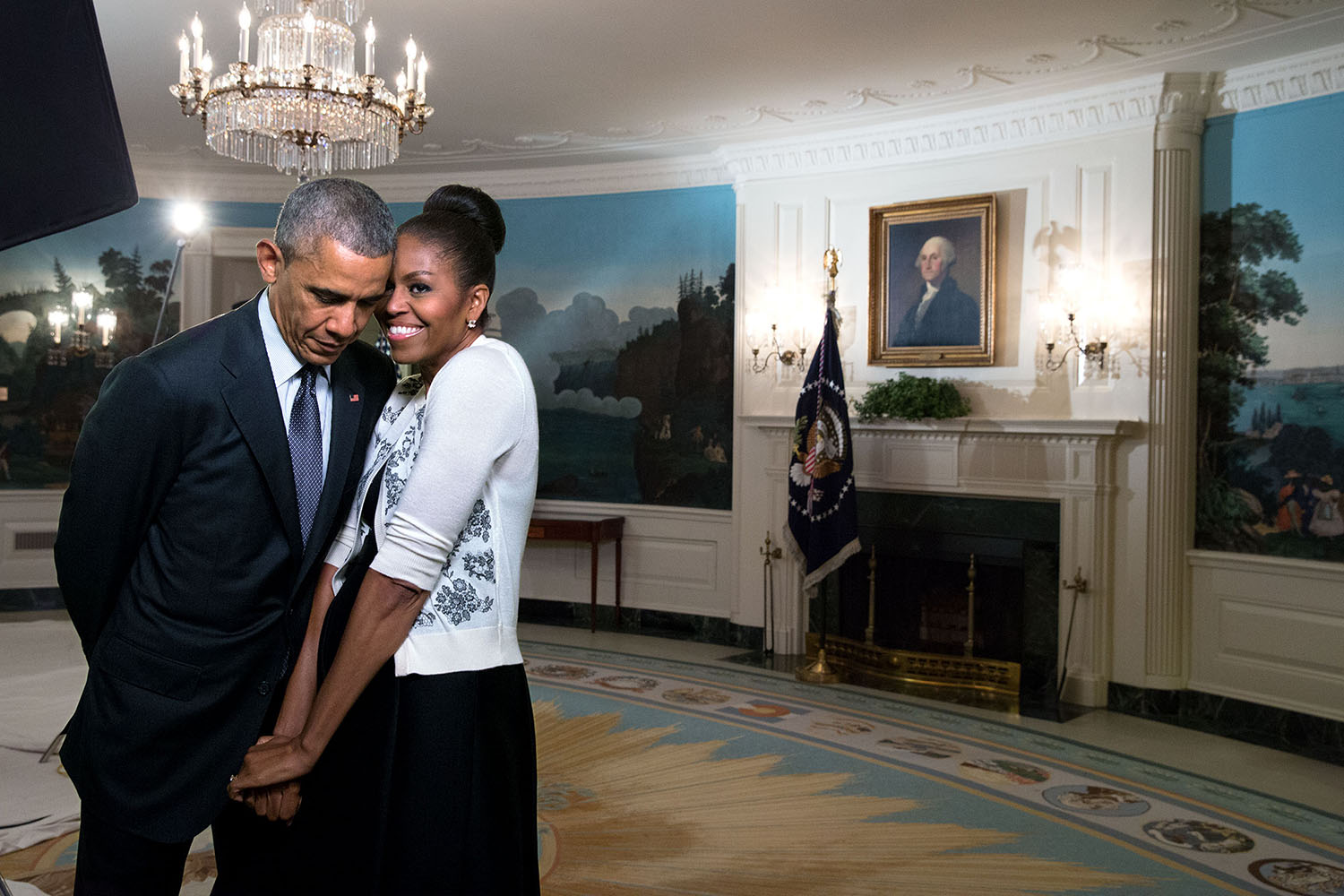 PHOTO: First lady Michelle Obama snuggles with President Barack Obama during a video taping in the Diplomatic Reception Room of the White House, March 27, 2015.