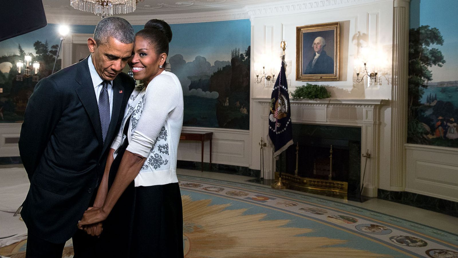 PHOTO: First lady Michelle Obama snuggles with President Barack Obama during a video taping in the Diplomatic Reception Room of the White House, March 27, 2015.