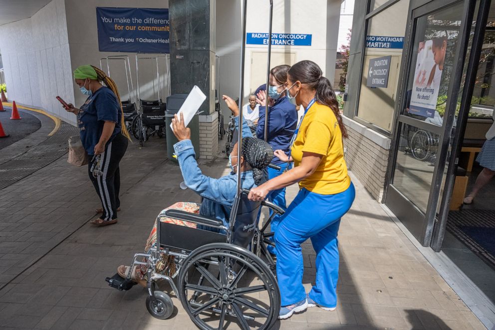 PHOTO: Ochsner Medical Center staff lined the hallways to celebrate on Monday as its 1,500th COVID-19 patient was discharged.