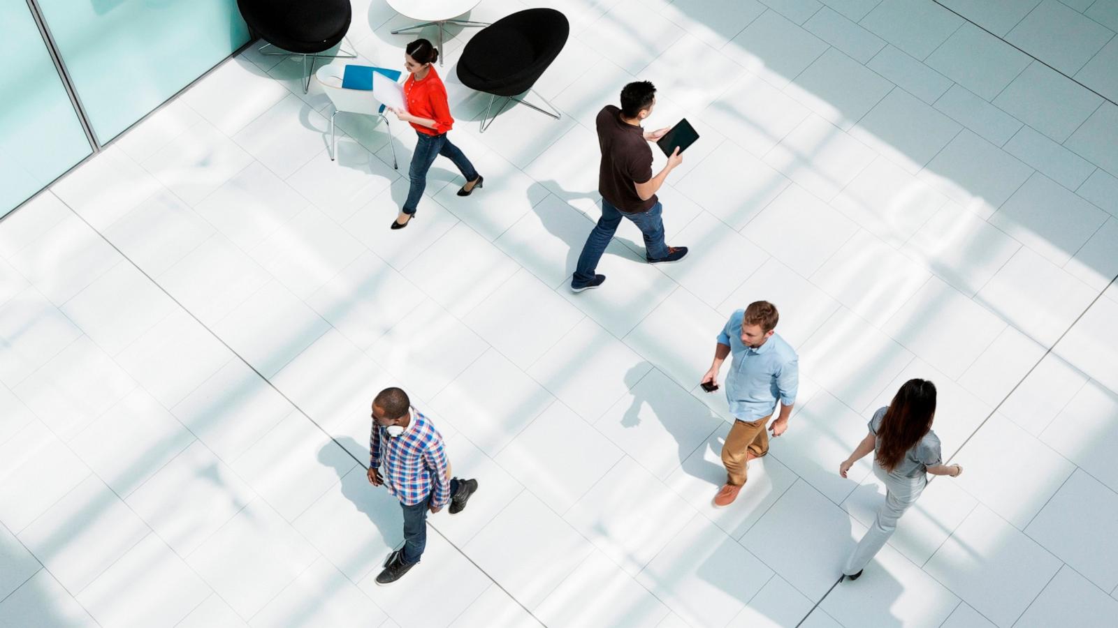 PHOTO: Stock image of people walking through an office.