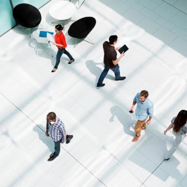 PHOTO: Stock image of people walking through an office. 