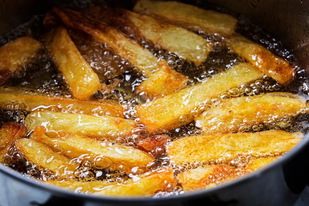 PHOTO: Stock photo of french fries cooking in oil.