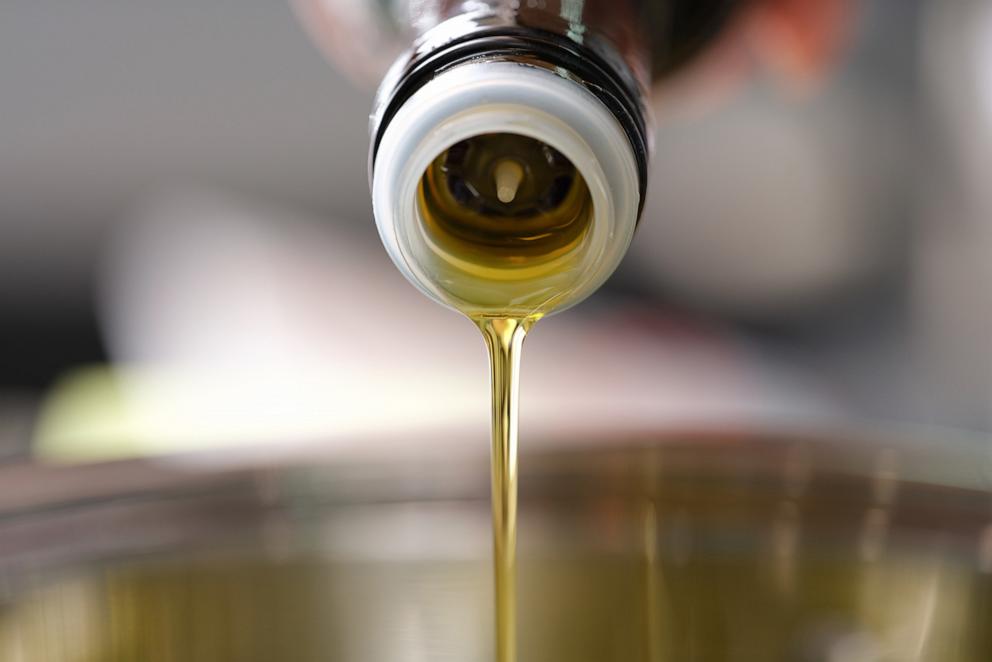 PHOTO: Stock photo of oil being poured into a pan.