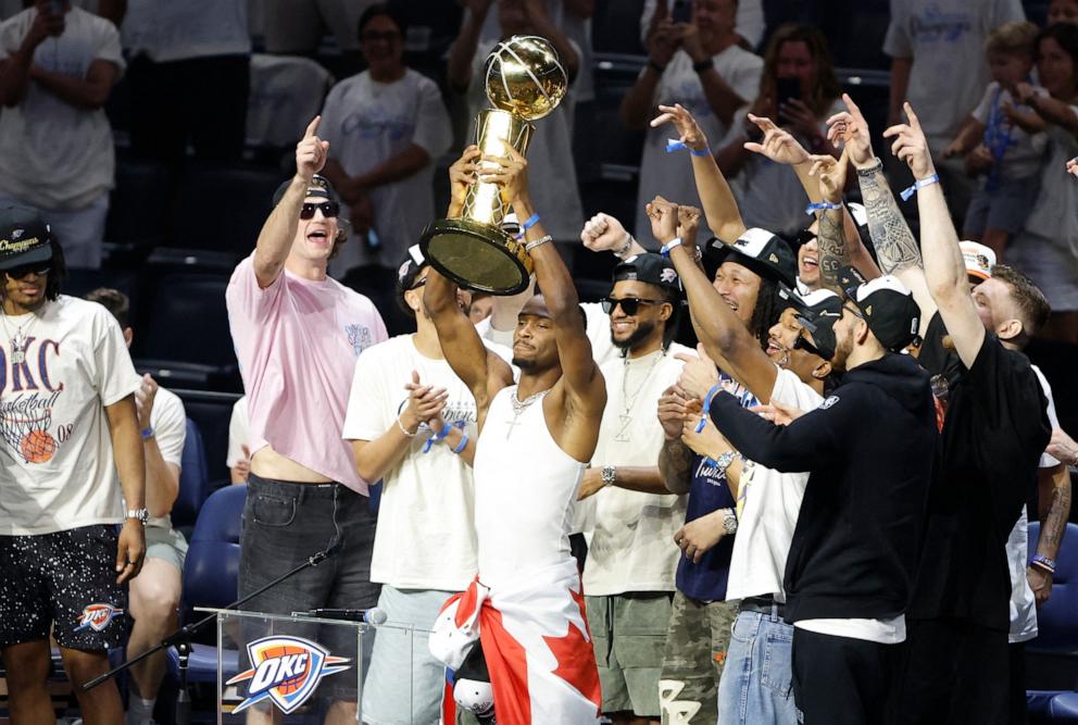 PHOTO: Oklahoma City Thunder guard Shai Gilgeous-Alexander holds up the Larry O'Brien Championship Trophy during the Champions Opening Ceremony for the parade inside the Paycom Center, June 24, 2025, in Oklahoma City, Oklahoma.