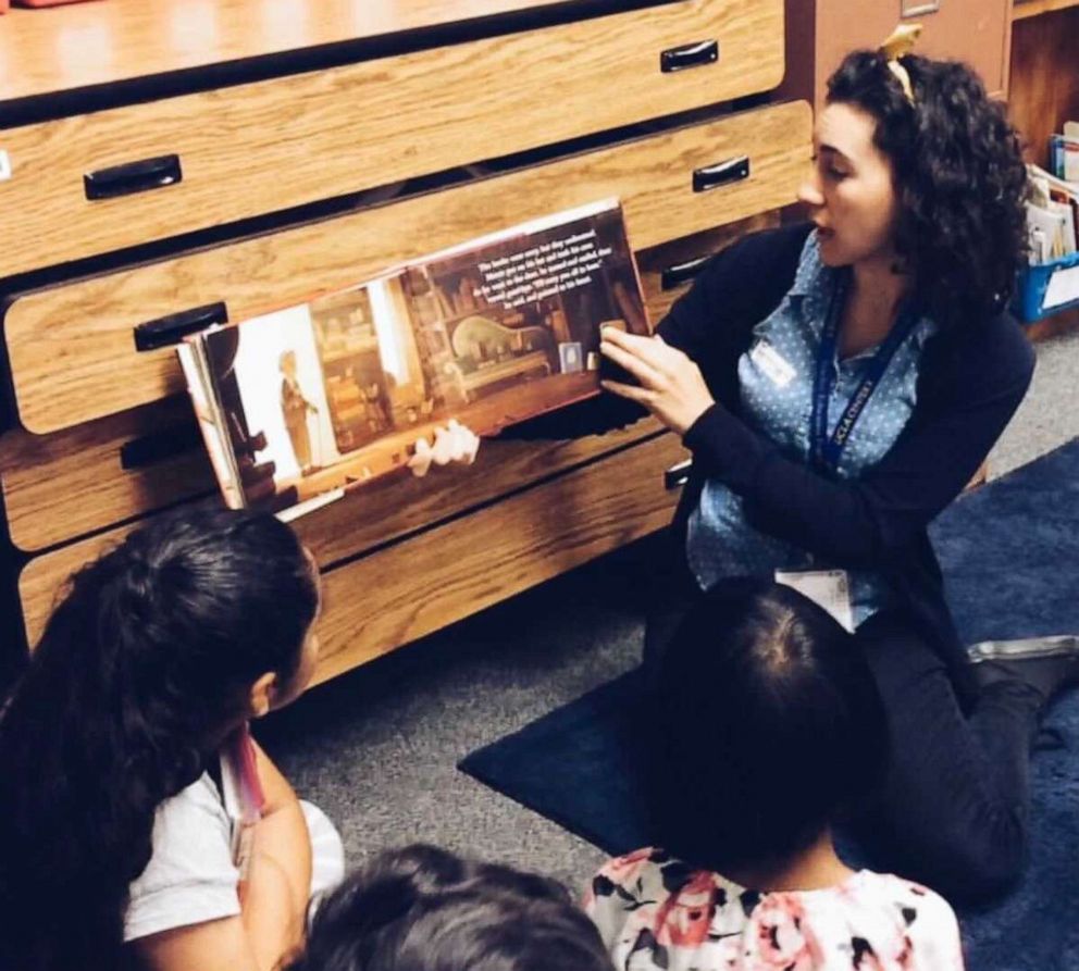 PHOTO: Sophie Oleniacz, 27, reading a book to her students.