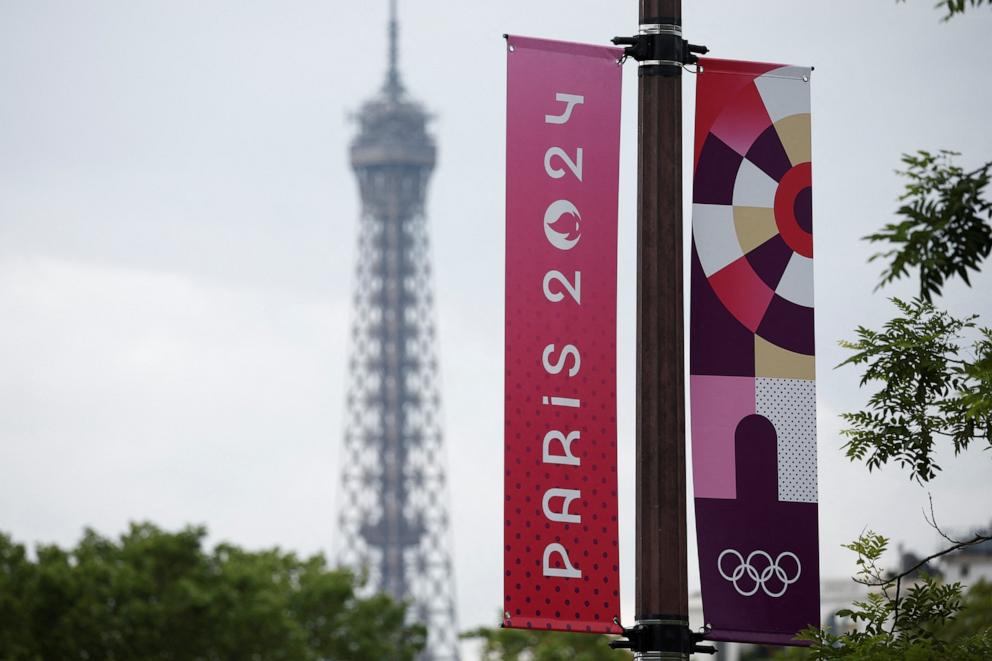 PHOTO: Olympic signage is displayed with the Eiffel Tower in the background ahead of the Paris 2024 Olympic games in Paris, June 20, 2024.