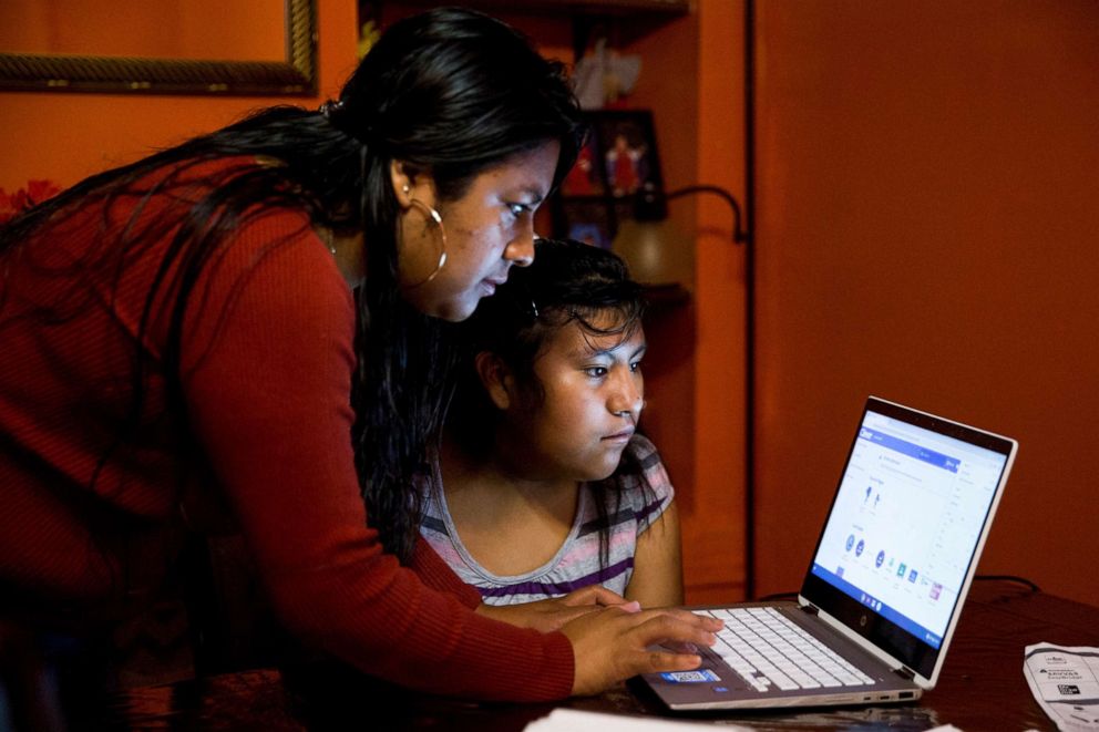 PHOTO: In this Sept. 18, 2020, file photo, Belen Cruz tries to help her daughter, Natalie, log on to her school's online learning platform at their home in York, Penn., Sept. 18, 2020.