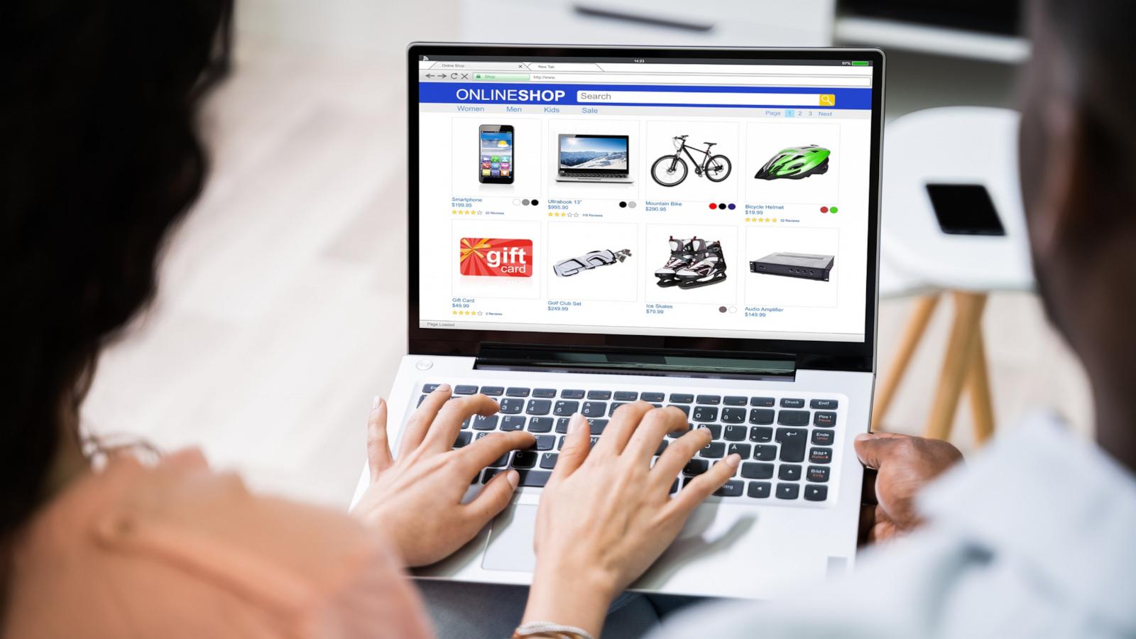 PHOTO: Close-up of a couple shopping online on a laptop.