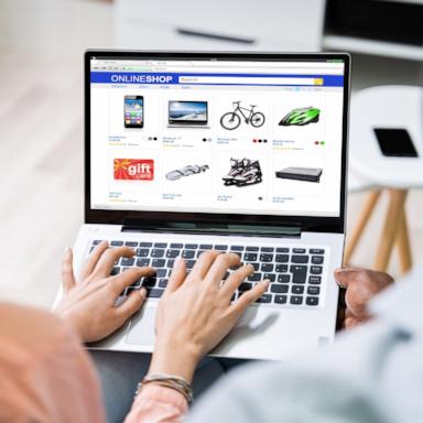 PHOTO: Close-up of a couple shopping online on a laptop.