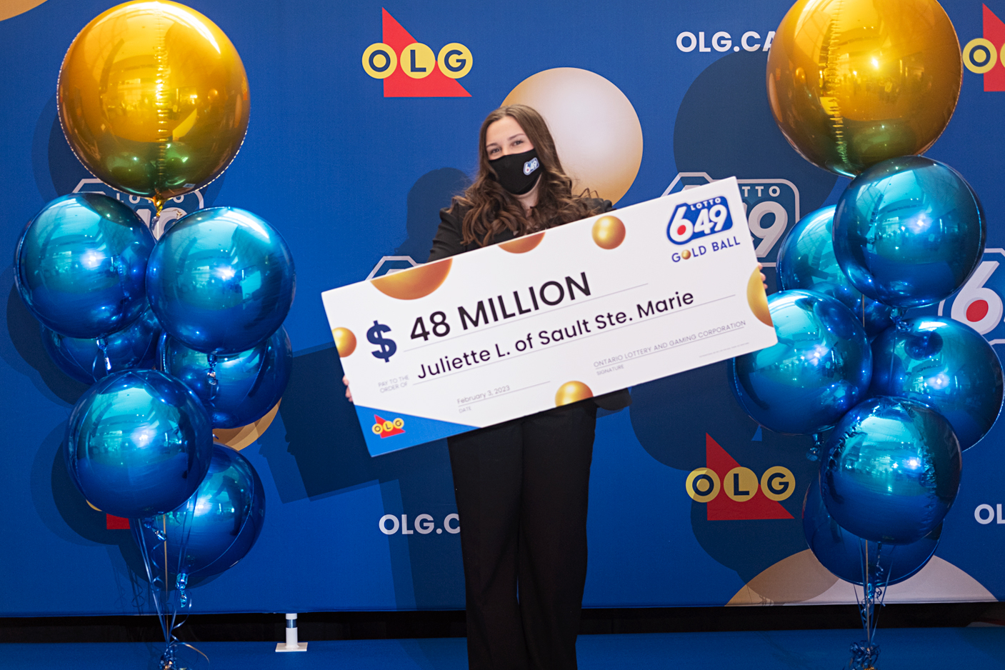 PHOTO: Juliette Lamour poses for a photo with an oversized check after winning a $48 million lottery.