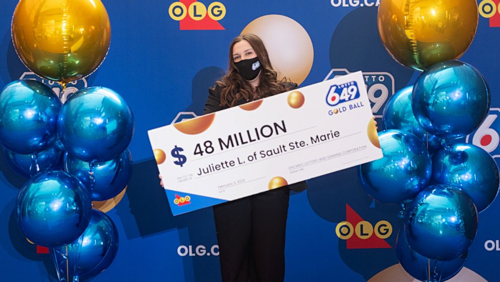 PHOTO: Juliette Lamour poses for a photo with an oversized check after winning a $48 million lottery.