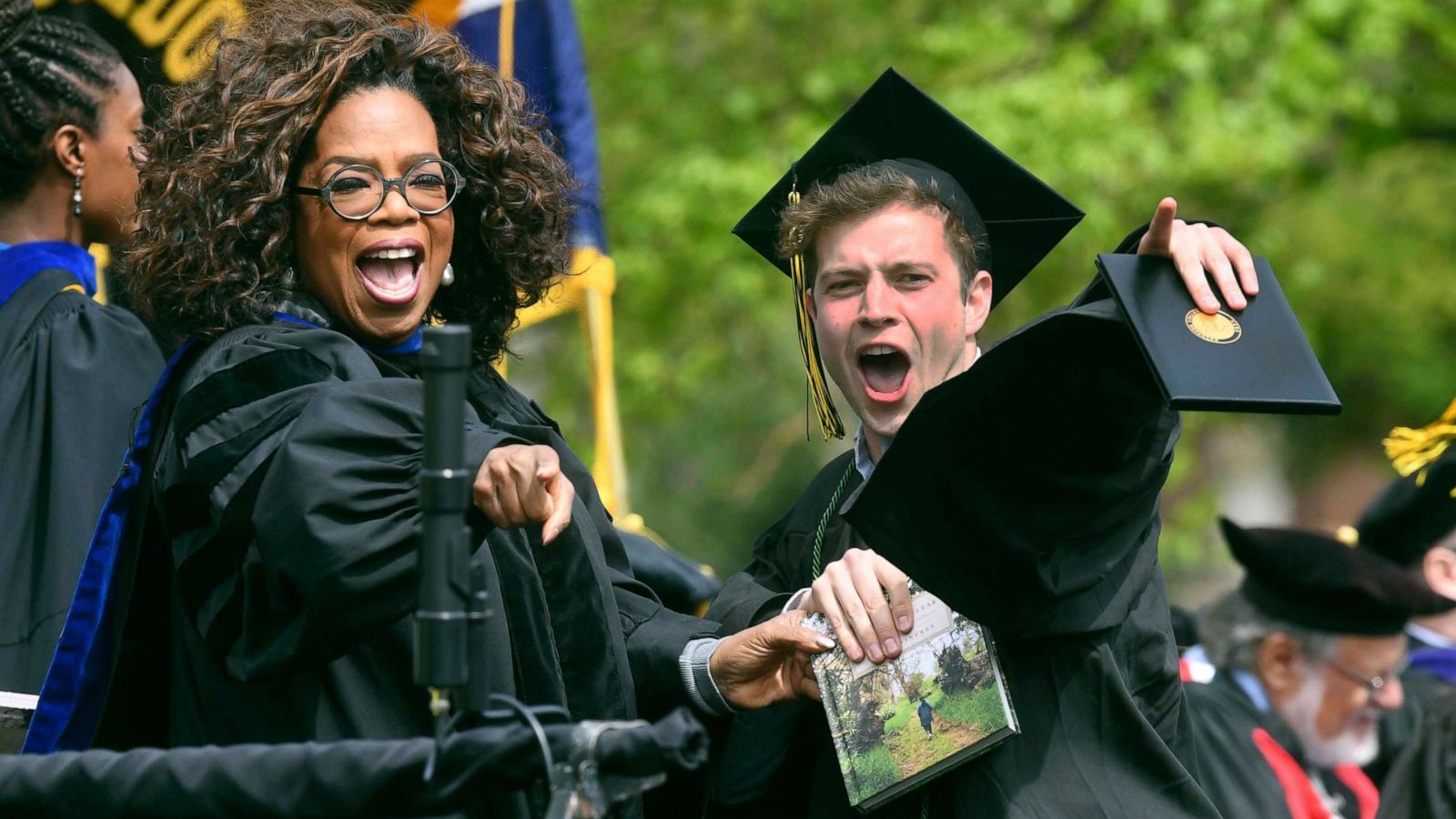 PHOTO: Colorado College graduate Alexander Jobin-Leeds reacts together with commencement speaker Oprah Winfrey to someone in the audience at Colorado College graduation in Colorado Springs, Colo., May 19, 2019.