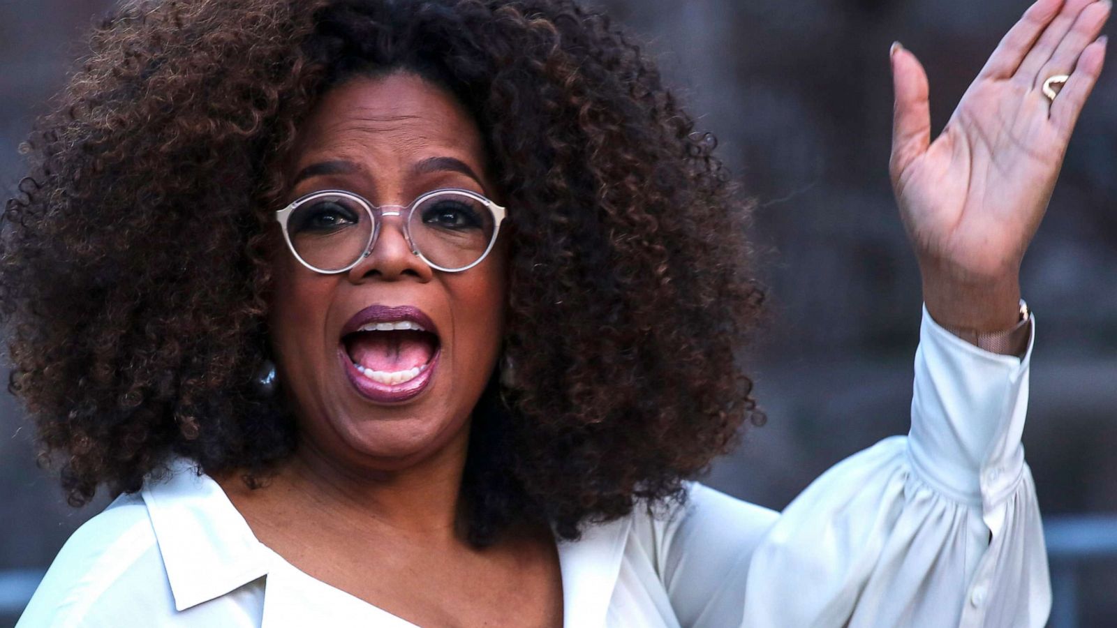 PHOTO: Oprah Winfrey waves as she arrives to the opening celebration of the Statue of Liberty Museum on Liberty Island in New York, May 15, 2019.