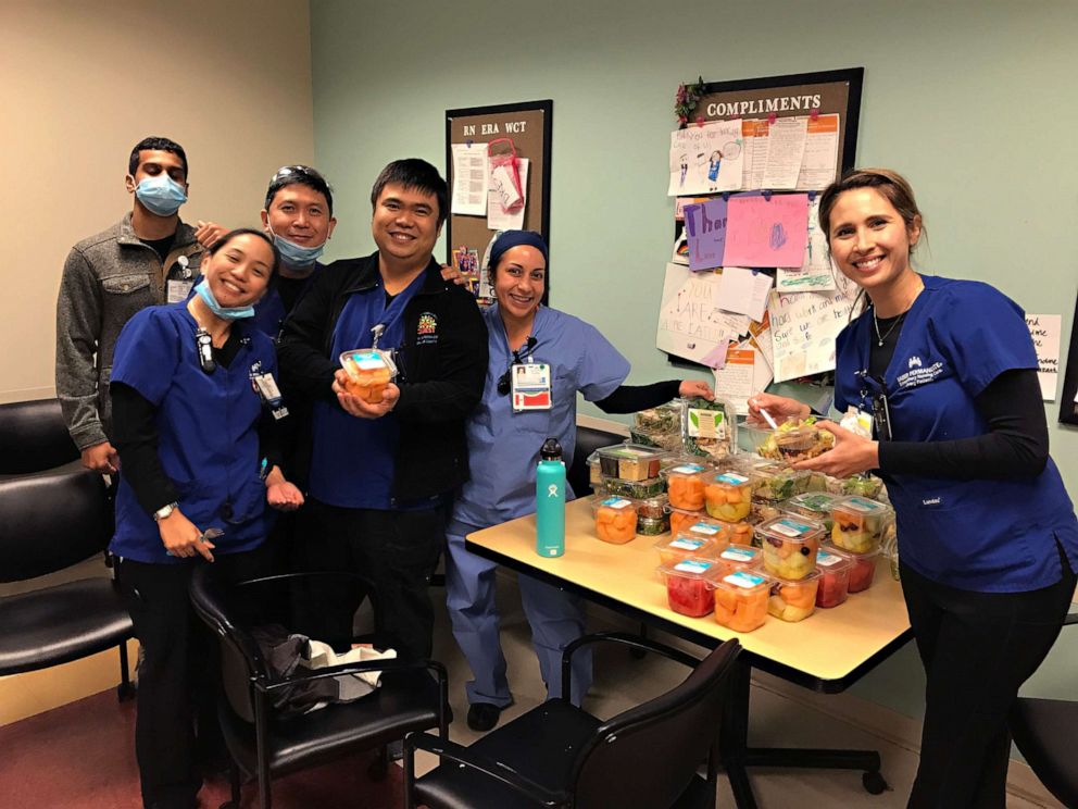 PHOTO: Lauren Mochizuki, far right, and her colleagues stand by food donated to their Orange County, California, hospital.