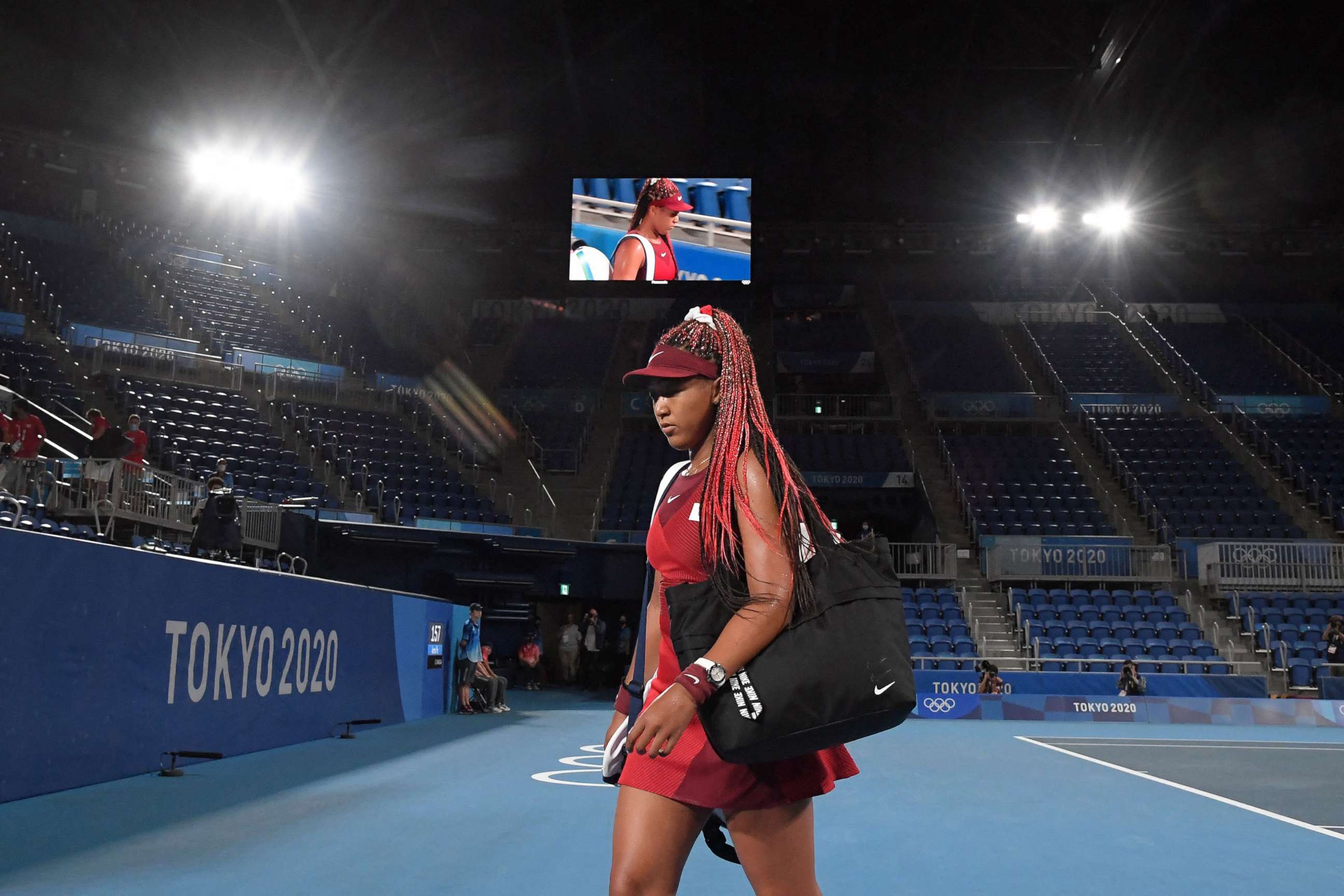PHOTO: Japan's Naomi Osaka leaves the court after being beaten by Czech Republic's Marketa Vondrousova in their Tokyo 2020 Olympic Games women's singles third round tennis match at the Ariake Tennis Park in Tokyo on July 27, 2021.