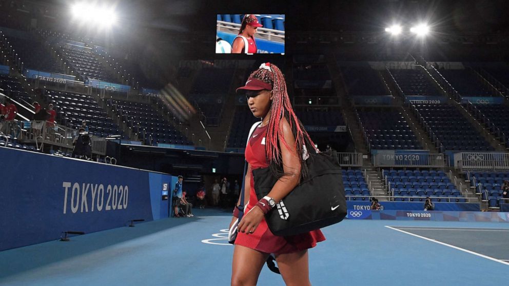 PHOTO: Japan's Naomi Osaka leaves the court after being beaten by Czech Republic's Marketa Vondrousova in their Tokyo 2020 Olympic Games women's singles third round tennis match at the Ariake Tennis Park in Tokyo on July 27, 2021.