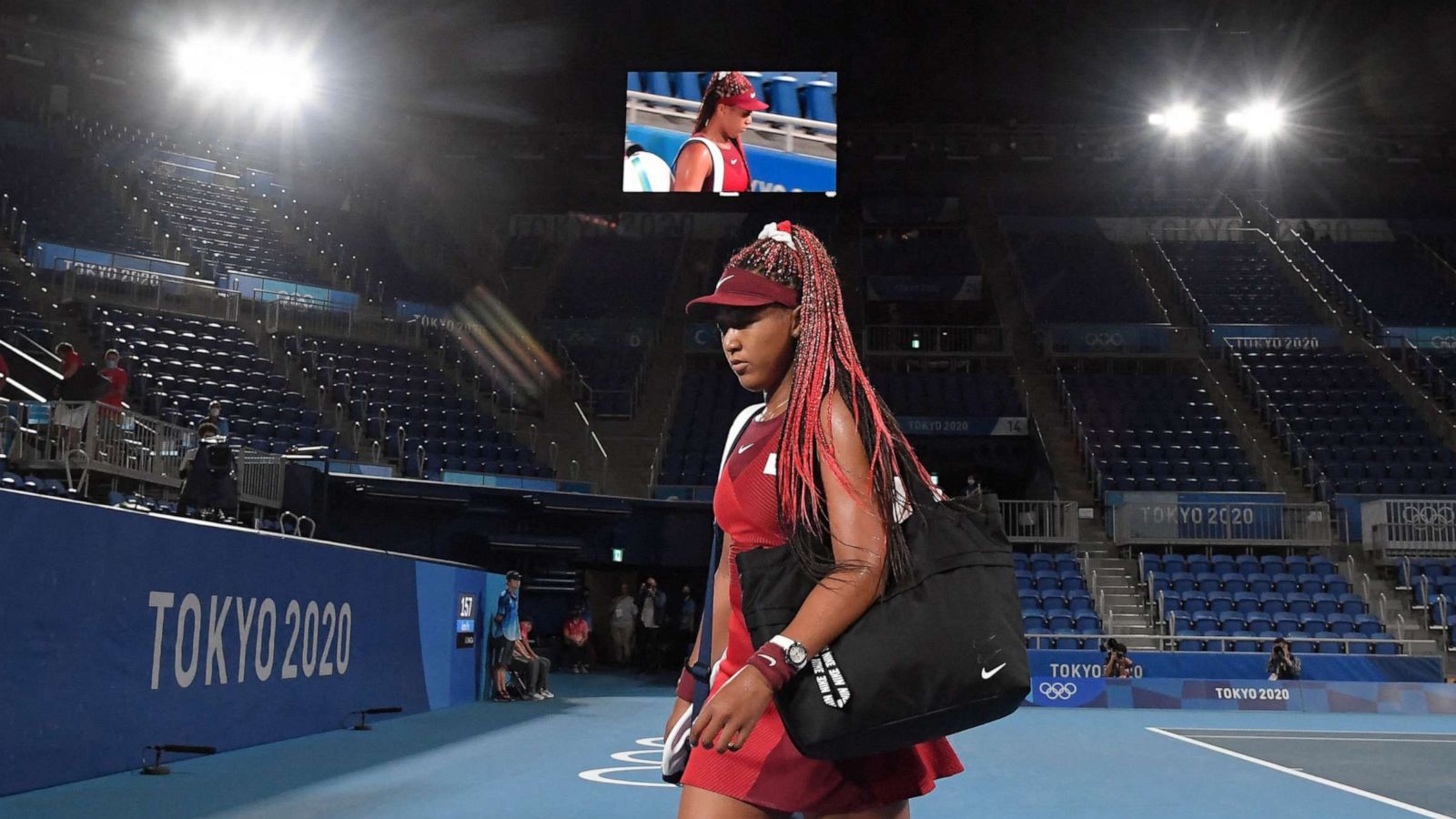 PHOTO: Japan's Naomi Osaka leaves the court after being beaten by Czech Republic's Marketa Vondrousova in their Tokyo 2020 Olympic Games women's singles third round tennis match at the Ariake Tennis Park in Tokyo on July 27, 2021.