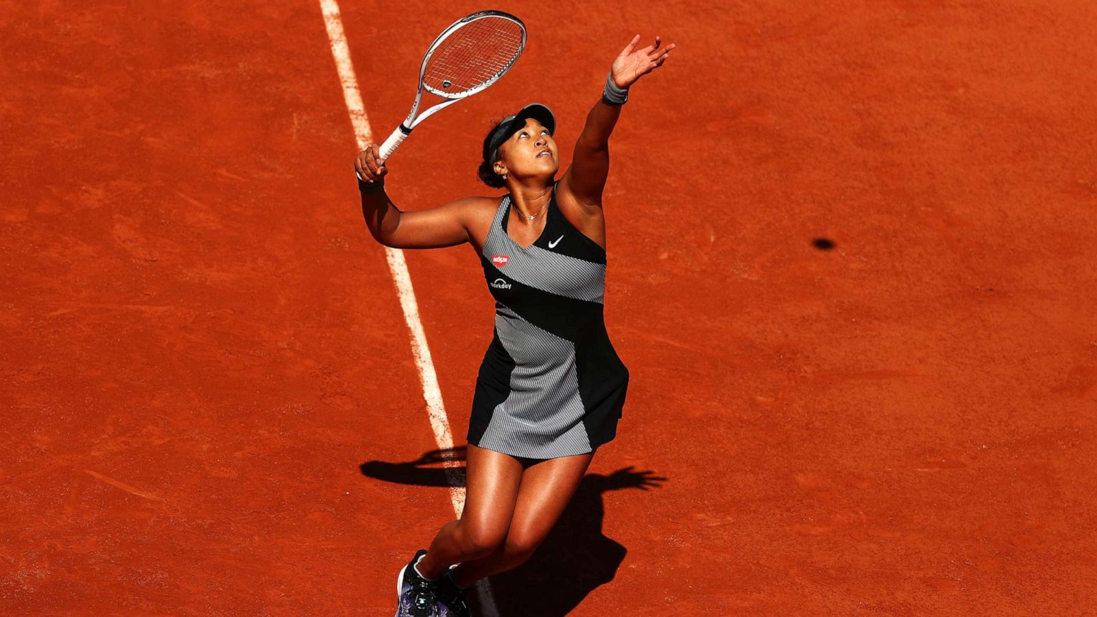 PHOTO: Naomi Osaka serves in her match against Patricia Maria Tig of Romania during Day One of the 2021 French Open at Roland Garros, May 30, 2021, in Paris.