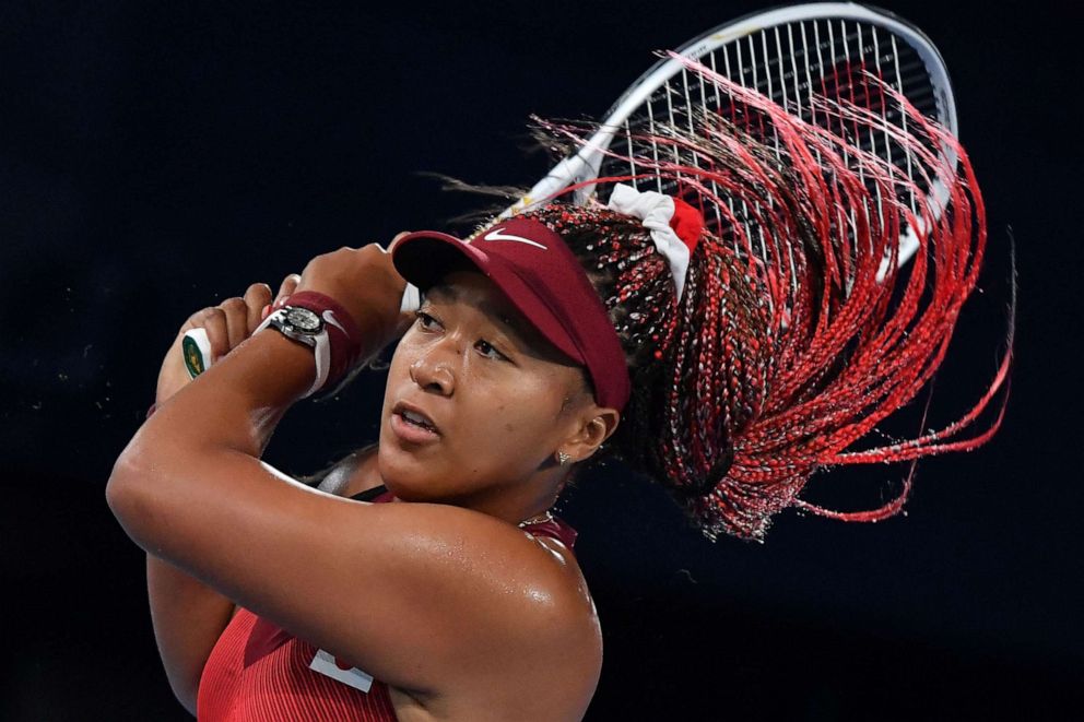 PHOTO: Japan's Naomi Osaka returns the ball to Czech Republic's Marketa Vondrousova during their Tokyo 2020 Olympic Games women's singles third round tennis match at the Ariake Tennis Park in Tokyo on July 27, 2021.