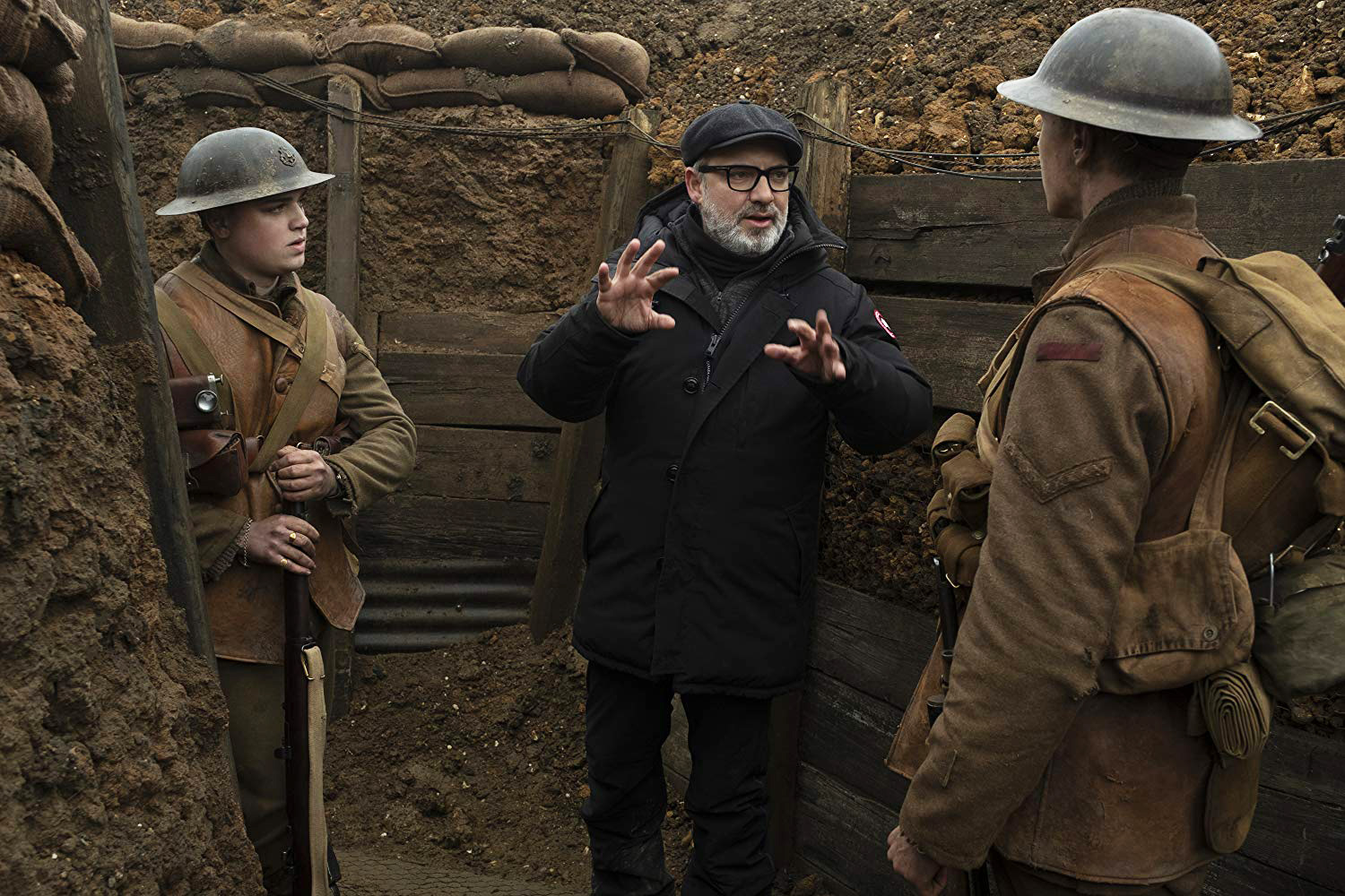 PHOTO: Director Sam Mendes speaks with actors George McKay and Dean-Charles Chapman on the set of the 2019 film, "1917."