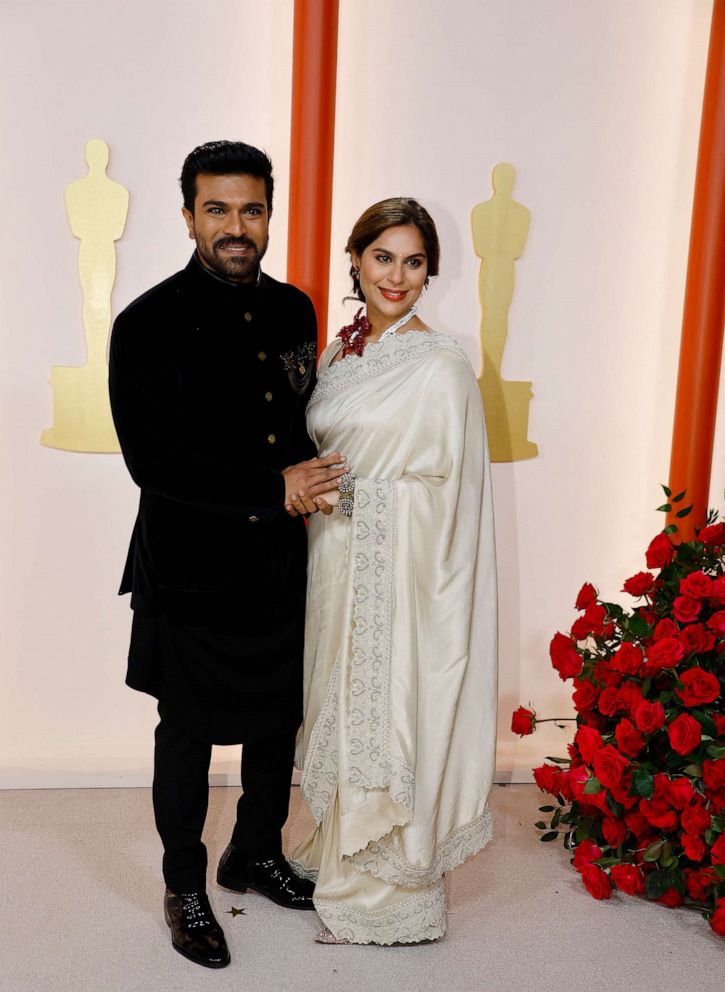 PHOTO: Ram Charan and wife Upasana Kamineni pose on the champagne-colored red carpet during the Oscars arrivals at the 95th Academy Awards in Hollywood, Los Angeles, March 12, 2023.