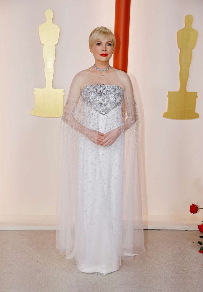 PHOTO: Michelle Williams poses on the champagne-colored red carpet during the Oscars arrivals at the 95th Academy Awards in Hollywood, Los Angeles, March 12, 2023.