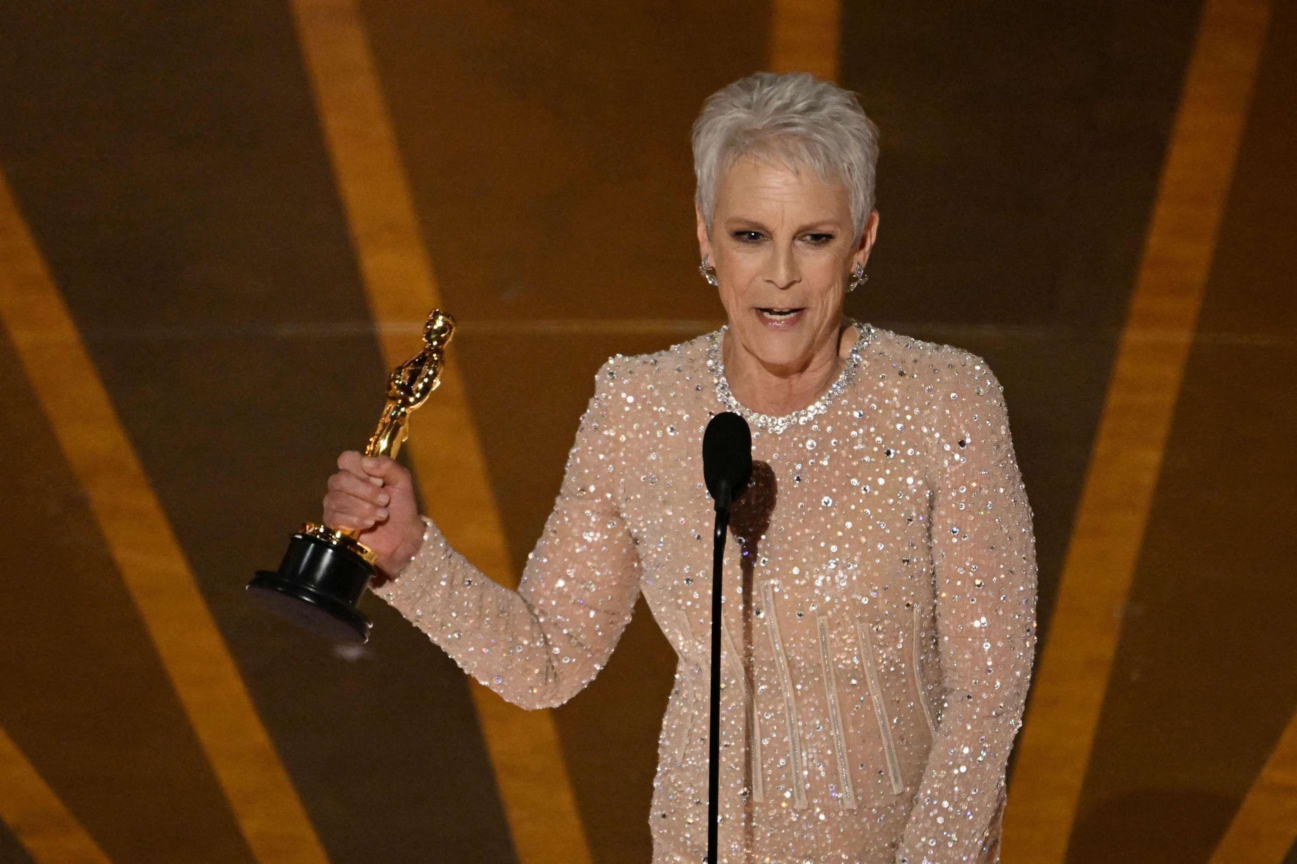 PHOTO: Jamie Lee Curtis accepts the Oscar for Best Actress in a Supporting Role for "Everything Everywhere All at Once" onstage during the 95th Annual Academy Awards at the Dolby Theatre in Hollywood, California on March 12, 2023.
