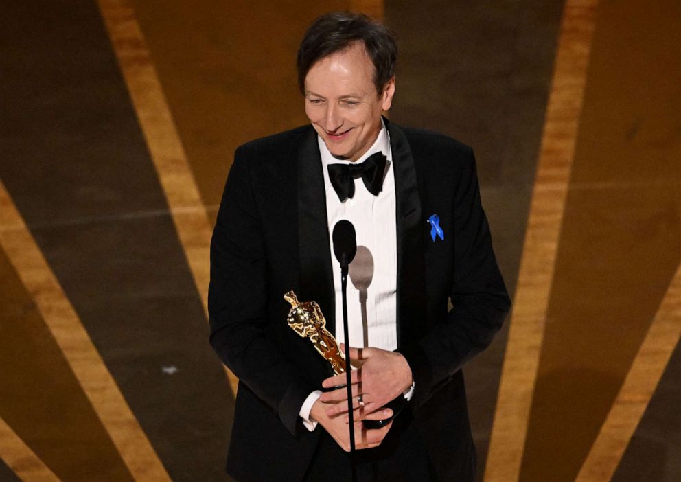 PHOTO: German composer Volker Bertelmann accepts the Oscar for Best Music (Original Score) for "All Quiet on the Western Front" onstage during the 95th Annual Academy Awards at the Dolby Theatre in Hollywood, California on March 12, 2023.