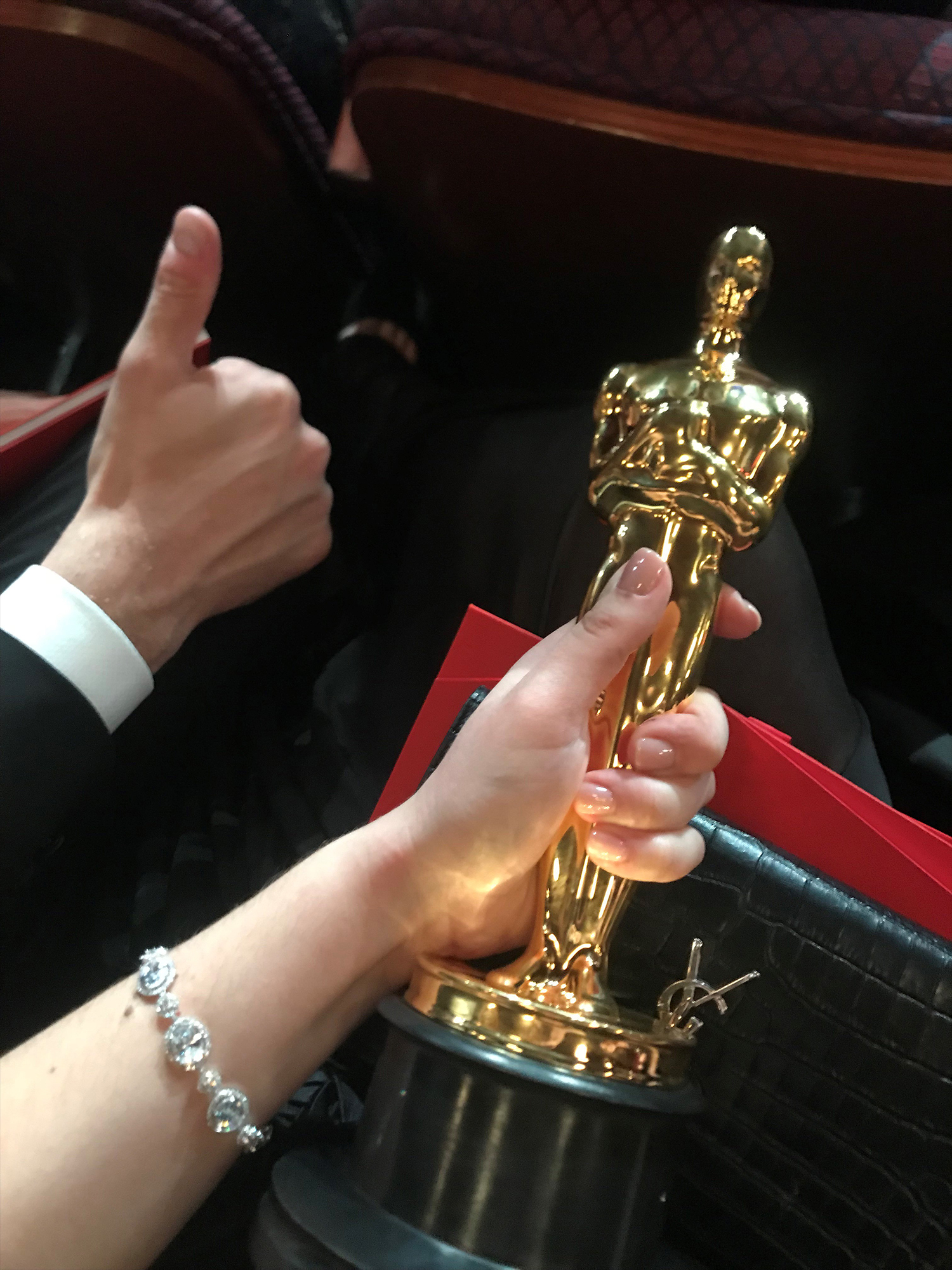 PHOTO: Rayka Zehtabchi and Sam Davis hold their Oscar inside the Dolby Theatre.