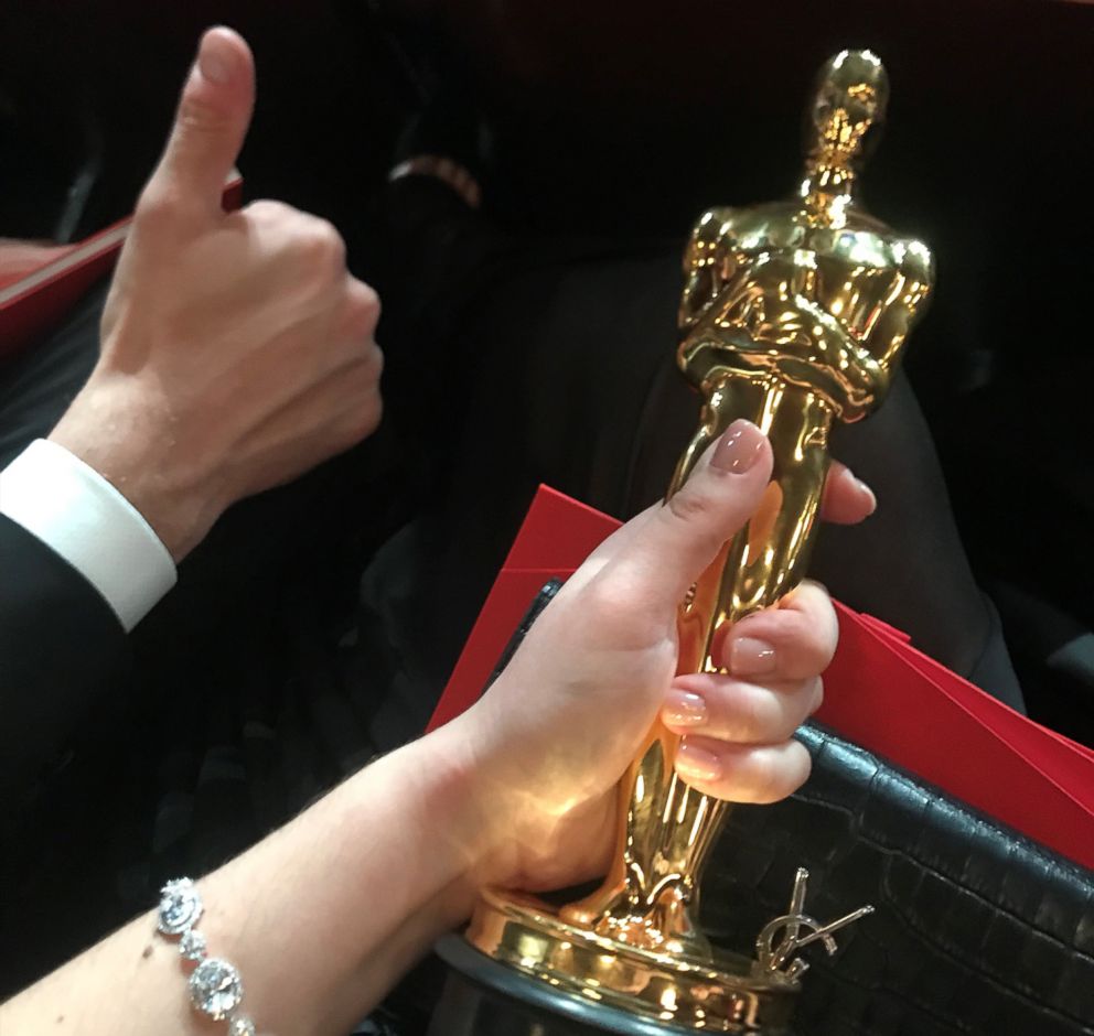 PHOTO: Rayka Zehtabchi and Sam Davis hold their Oscar inside the Dolby Theatre.