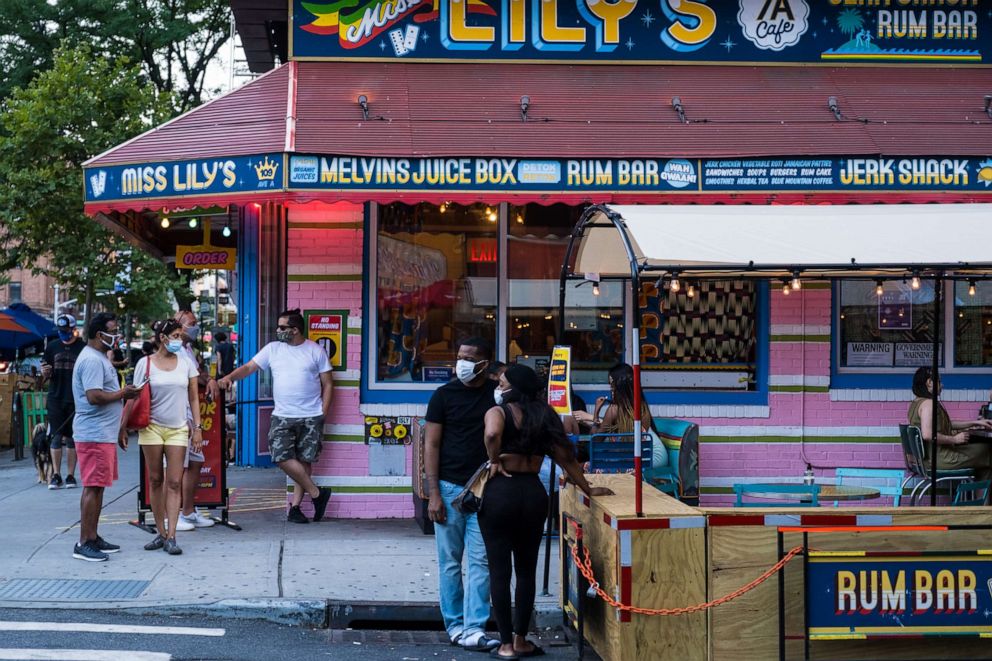 PHOTO: People wait in line outside a restaurant in the East Village on July 21, 2020, in New York.