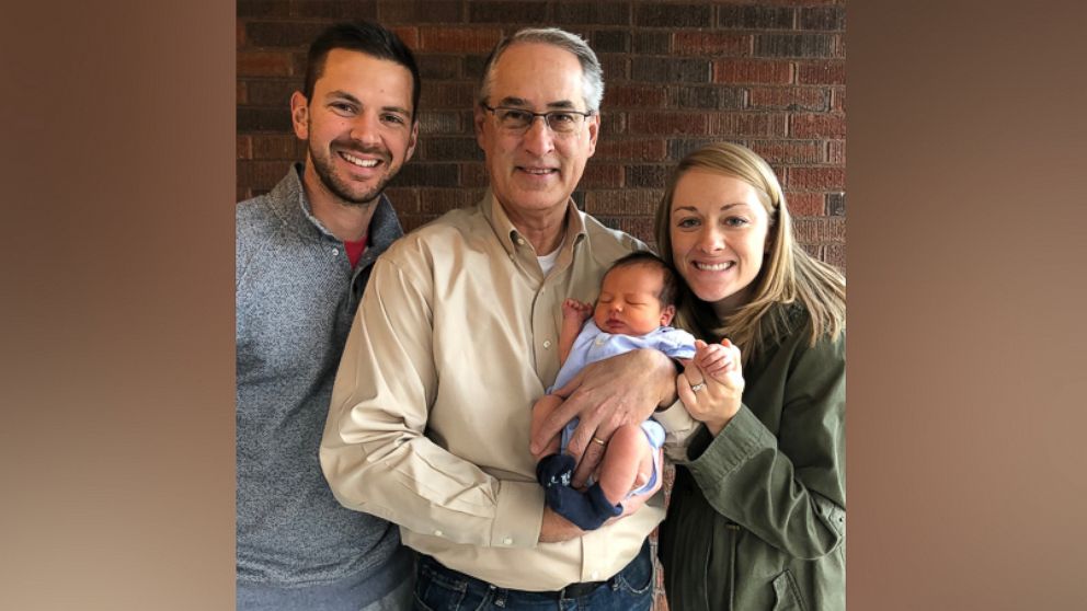 PHOTO: Doug Walton seen with his daughter, Kimberly Demchak, son-in-law Mark Demchak and grandson Eli Demchak. Eli is the eighth child in the family to wear the blue going-home outfit from the hospital after birth.