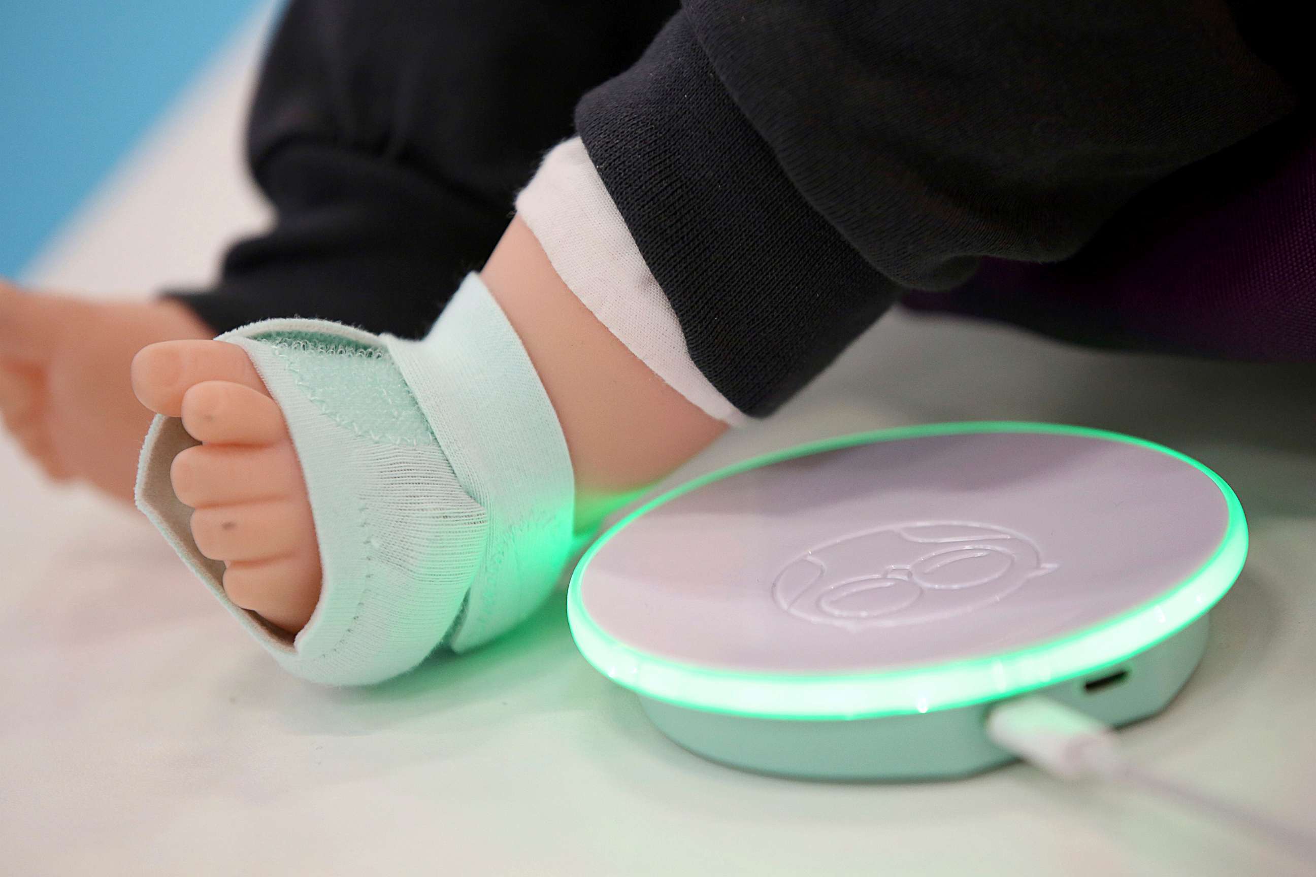 PHOTO: An Owlet Smart Sock which checks blood pressure, heart rhythm, and blood oxygen levels is attached to the foot of a doll.