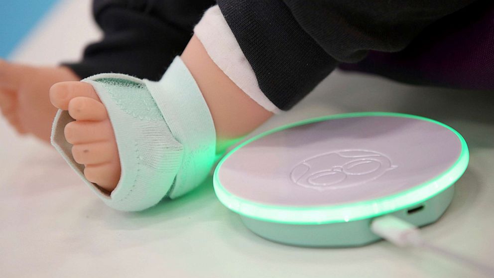 PHOTO: An Owlet Smart Sock which checks blood pressure, heart rhythm, and blood oxygen levels is attached to the foot of a doll.