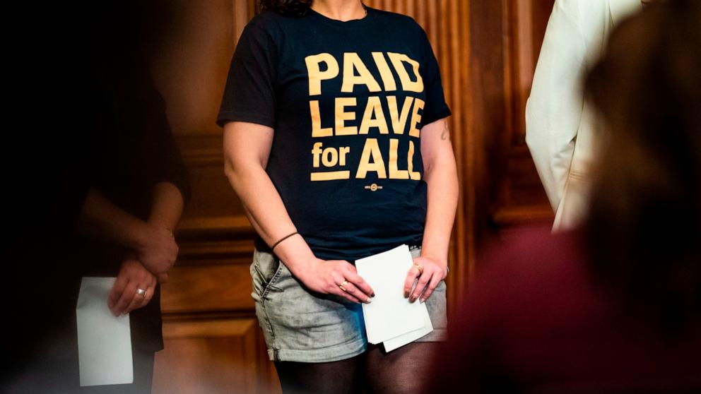 PHOTO: In this March 15, 2022 file photo, Bethany Fauteux, a member of Paid Leave for All's Voices of Workers Advisory Group wears a t-shirt reading "Paid Leave for All" during an Equal Pay Day event on Capitol Hill in Washington.