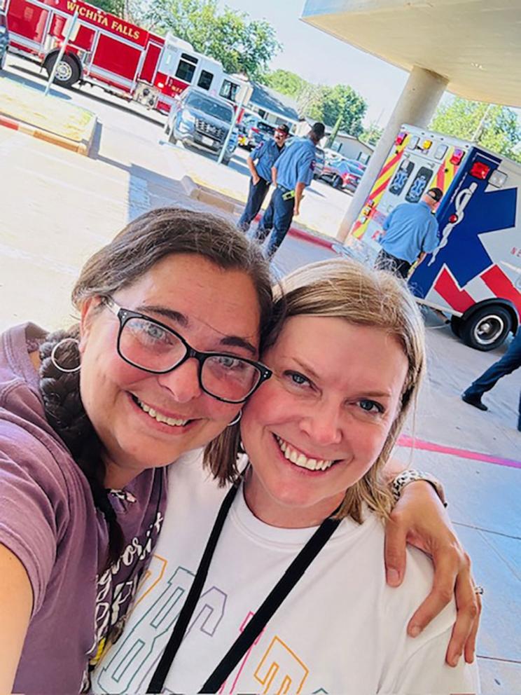 PHOTO: Ashley Strain, left, and Amy Simmons pose together after helping a colleague deliver her baby at school.