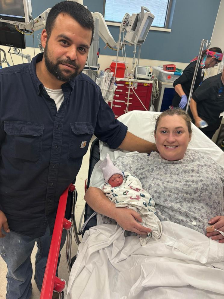 PHOTO: Paige Lockstedt and her husband pose with their newborn daughter.