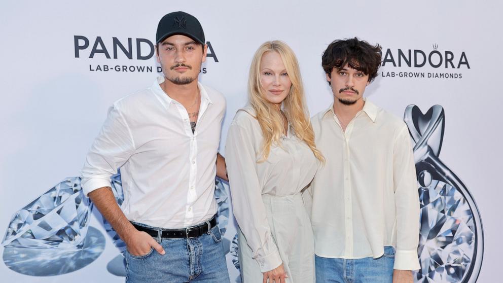 PHOTO: (L-R) Brandon Lee, Pamela Anderson, Dylan Lee attend as Pandora Celebrates Lab Grown Diamonds With A New Diamond District on Sept. 06, 2023 in New York City.