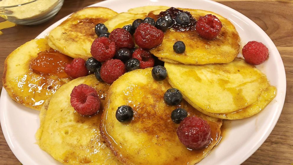Alex Guarnaschelli's cornmeal buttermilk pancakes with spiced maple syrup and fresh berries.