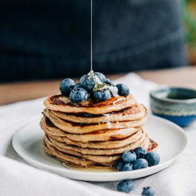 Pancakes with blueberries and honey.